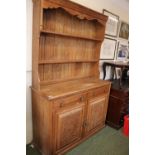 Early 20thC Oak Dresser with panel back over 2 drawers with brass drop handles and 2 Carved panelled