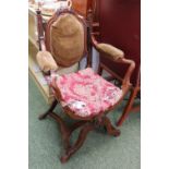 Victorian Oak framed Elbow chair with upholstered seat, back and arms, on cruciform support.