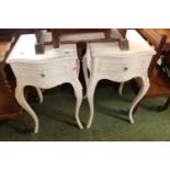Pair of White bedside tables with single drawers over outstretched legs