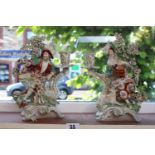 Pair of Unmarked figural candlesticks in the style of Derby, of a Gentleman and Lady, with bocage of