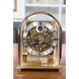 Kieninger skeleton clock, domed brass case, the movement striking on eight gongs, 20.5cm. With Key
