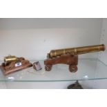 Unmarked Brass cannon on Oak base with brass fittings 34cm in Length and a squat Brass Cannon on Oak
