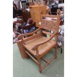 Heavily carved Throne chair with caned seat and Lions head arms over bobbin turned stretcher