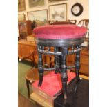 Victorian revolving upholstered piano stool with upholstered top and ebonised base