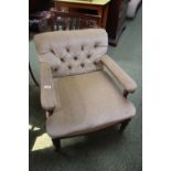 Victorian Button back low elbow chair with turned supports on metal casters