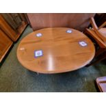 Ercol Blonde Elm Oval Coffee table with magazine rack to under tier on tapering legs