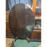 19thC Oval Oak Tilt top table on splayed legs and casters