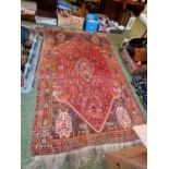 Large Red Ground Persian Rug with knotted tassels