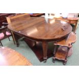 Edwardian wind out table with two leaves on brass casters with winder