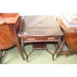 Edwardian Shaped top envelope card table with carved outstretched legs and brass handles