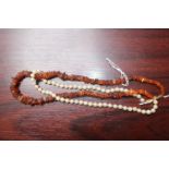 Ladies Pearl Necklace with Gold clasp and an Amber necklace