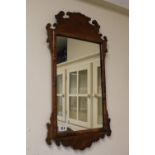 Georgian Walnut framed shaped wall mirror