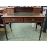 Edwardian green leather topped Ladies' desk of 2 drawers with brass drop handles over tapering legs.