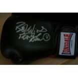 A Frank Bruno personally signed Lonsdale boxing glove in presentation case.