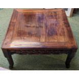 A CHINESE HUANGHUALI LOW TABLE CIRCA 1900 The square top with inset plank panel over carved