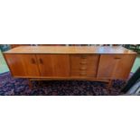 1970s Long Danish type sideboard of 4 drawers flanked by cupboards with cup handles 206cm in Length