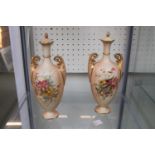 Pair of Royal Worcester Blush Ivory two handled vases with surmounted lids over floral decorated