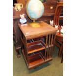 Edwardian Walnut Inlaid revolving bookcase with slatted sides and caster base