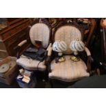 Pair of Carved Elbow chairs with upholstered seats and back and caster feet