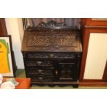 19thC Oak heavily Carved fall front bureau with fitted interior