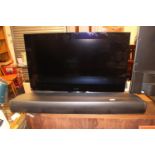 Bang and Olufsen TV with remote and sound bar