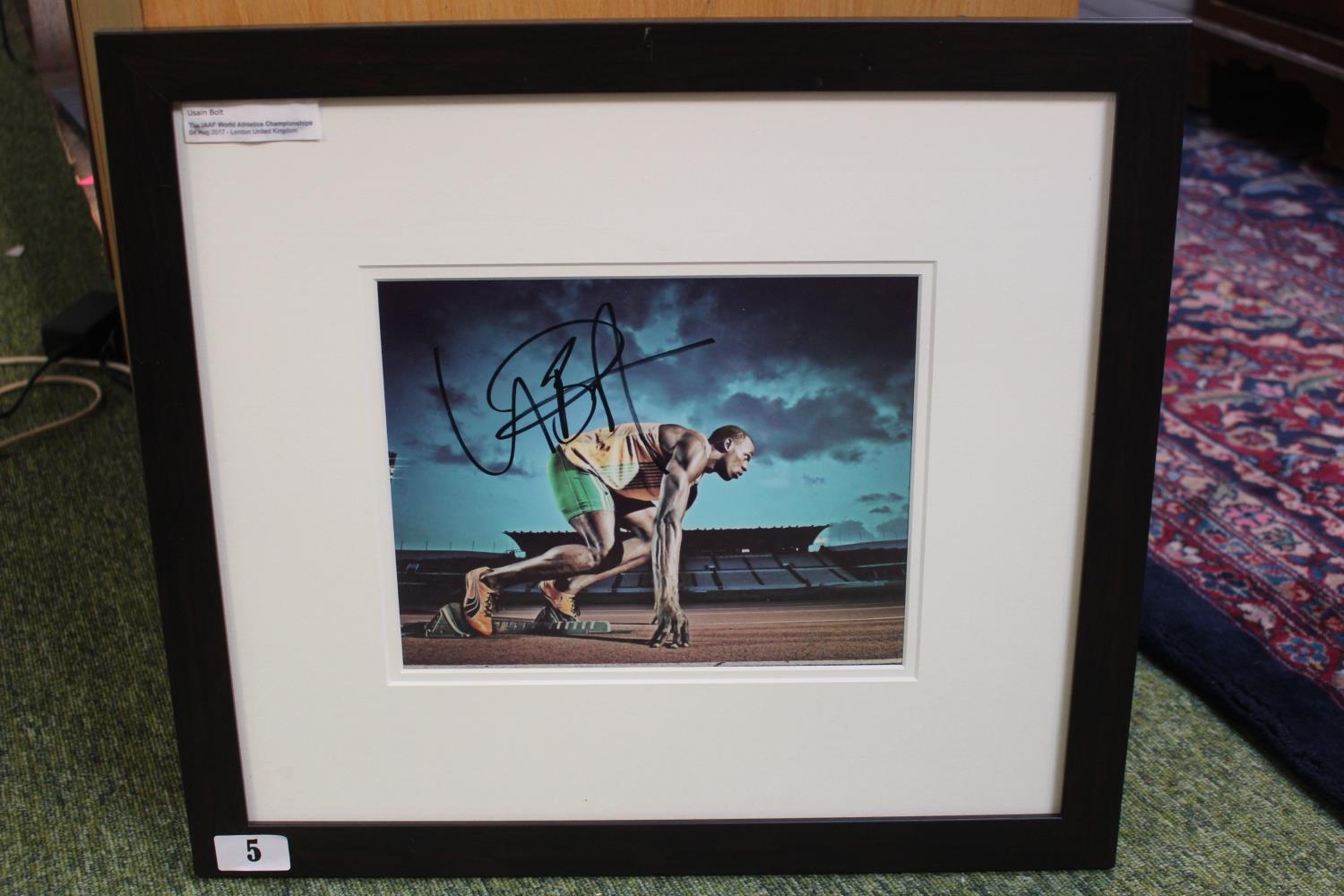 Usain Bolt Signed Photographic Print framed and mounted. 42 x 49cm