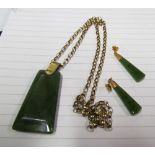 A gold chain with jade style pendant and a pair of earrings