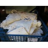 A crate of embroidered table linen and cloth