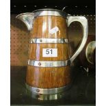 An oak jug with silver plated lid and banding