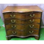 A George III serpentine fronted batchelor chest with blind fret corners on bracket feet