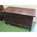 An 18th Century oak coffer panelled top and carved front