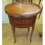 A similar oval gallery top chest of two drawers