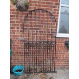 A wrought iron garden gate with accessories