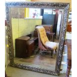 A large gilt framed rectangular decorative mirror