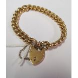 A rose gold coloured bracelet with padlock clasp marked 15