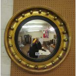 A gilt convex mirror