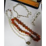 A strand of agate beads and two crystal bead necklaces