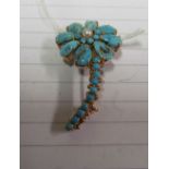 A turquoise and seed pearl flower brooch