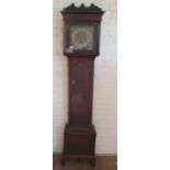 An oak longcase clock with brass face (weight and pendulum no ribbon)