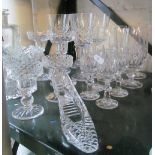 Four small glasses, four small flutes and other glass