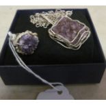 A white metal and amethyst ring, marked 835 and a similar necklace
