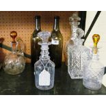 Five decanters and two green bottles