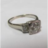An 18ct three stone diamond ring, centre stone approximately 1/2 carat size L/M 3.8g