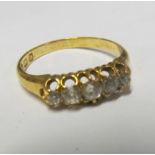 An 18ct gold five stone diamond ring size Q/R 3.4g