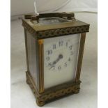 A brass carriage clock with basket weave border