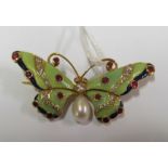 A yellow metal butterfly brooch marked 18k enamel, pearl, diamond and red stone