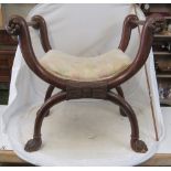 A 19th Century mahogany X frame stool with carved anthemion design to cross frame on heavily