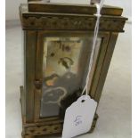 A French brass architectural mantel clock with urn surmount, cream dial movement marked Paris and