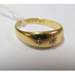 An 18ct gold three stone gypsy ring size T/U 2.9g