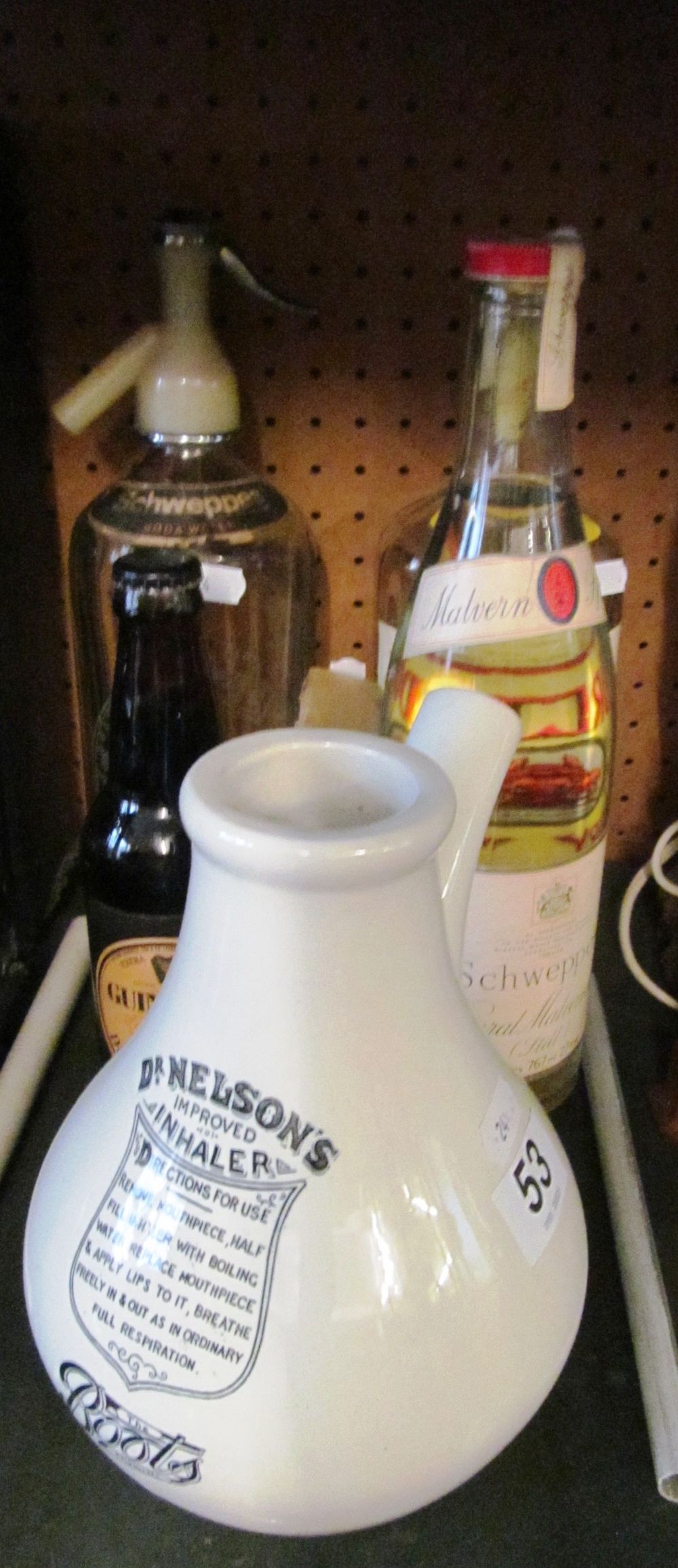 A Schweppes soda syphon and various vintage bottles including Guinness